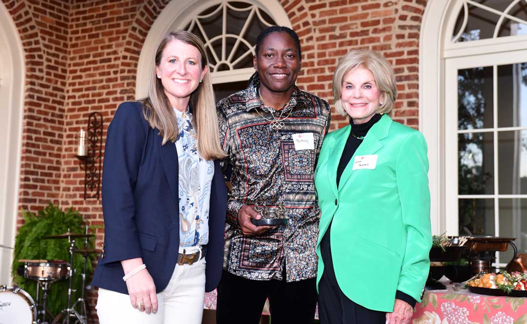 Brittney Reese, University of Mississippi alumna and celebrated Olympian, center, is presented with the Ole Miss Women's Council for Philanthropy's Emerging Young Philanthropist Award by Elizabeth Randall, left, immediate past OMWC chair, and Suzan Thames, current OMWC chair.