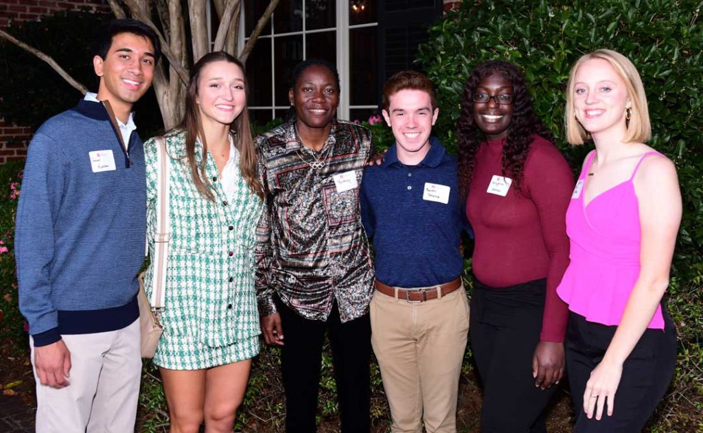 Brittney Reese, third from left, visits with OMWC scholars, from left, Daneel Konnar, Miley Ray, Benton Donahue, Amyaha Graham and Nadia Corder.