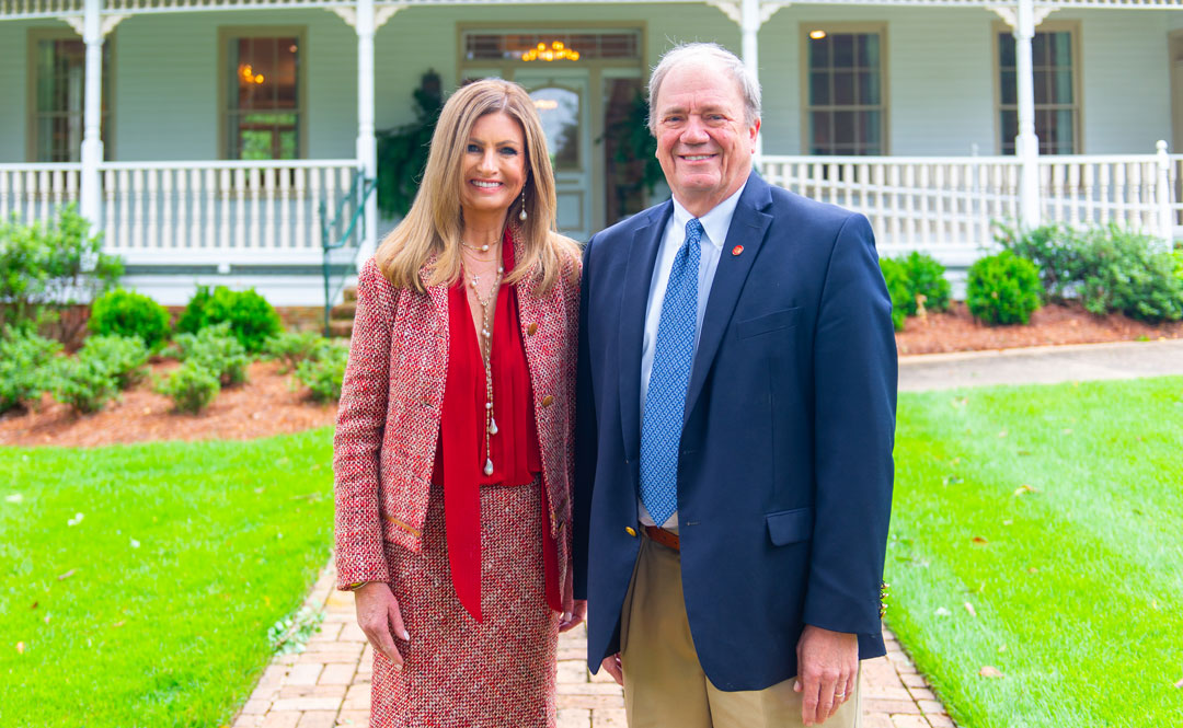 Mary Susan Gallien Clinton of Naples, Florida, at left, is providing leadership as chair of the Board of Directors of the University of Mississippi Foundation, which is celebrating the 50th anniversary of its founding this year. She is pictured with Wendell Weakley, president/CEO of the foundation in front of Brandt Memory House, home of the foundation. Photo by Bill Dabney/UMF