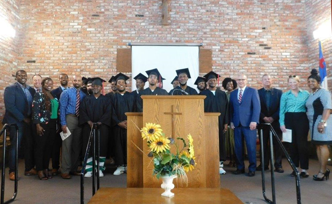 Several UM representatives have attended the course graduation ceremonies at the Mississippi State Penitentiary at Parchman, including Provost Noel Wilkin (fourth from right), who was there for the summer 2022 ceremony. Incarcerated students wear formal UM graduation attire, provided by the College of Liberal Arts.